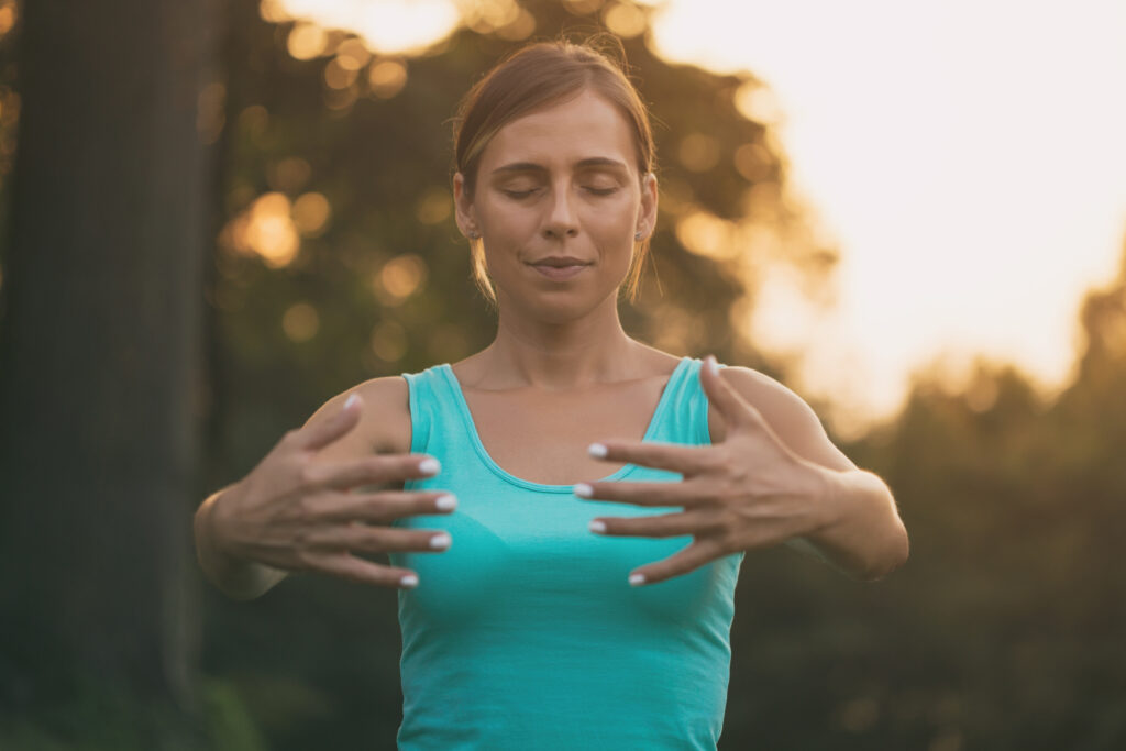 woman enjoys Tai Chi in nature.