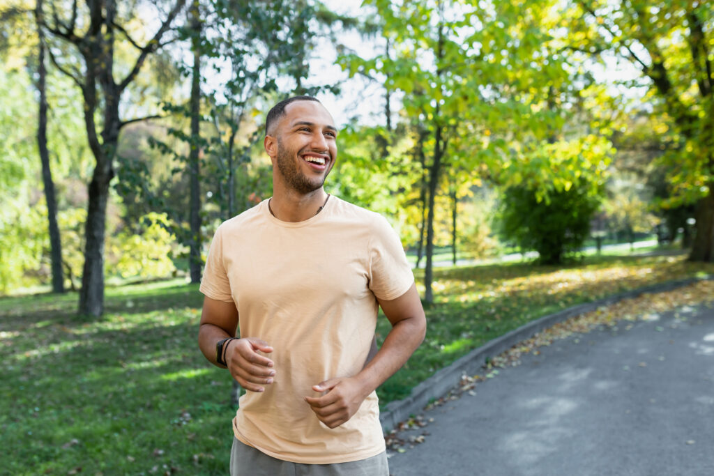 Cheerful man in park exercising as part of his summer pain relief plan
